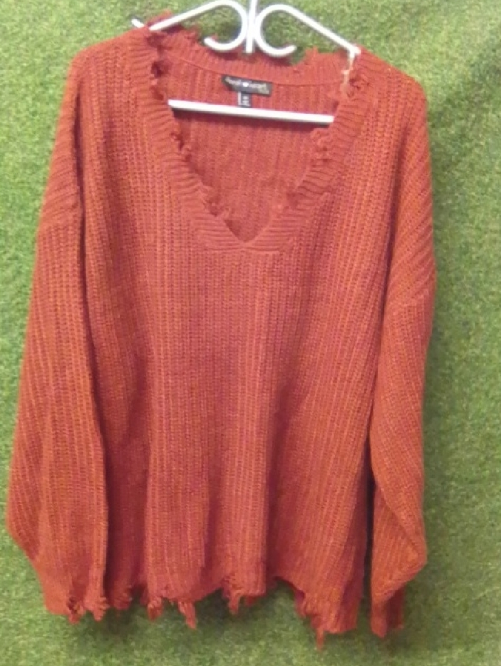 Derek Heart Distressed V‑Neck Sweater in Rust Orange